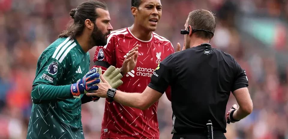 Liverpool players discussing with the referee during match