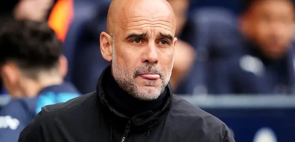 Bald coach observing the match from the sidelines