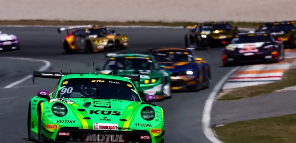Green racing car leading DTM race on track