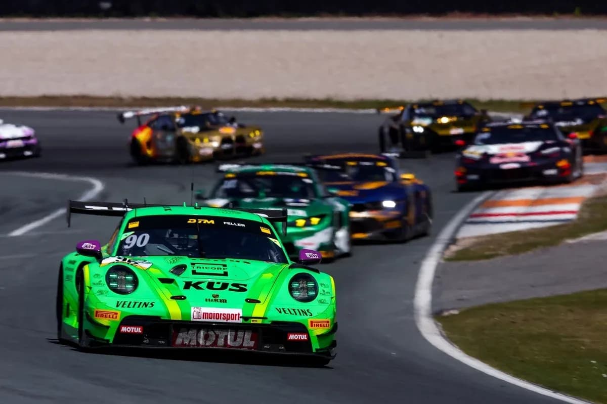 Green racing car leading DTM race on track
