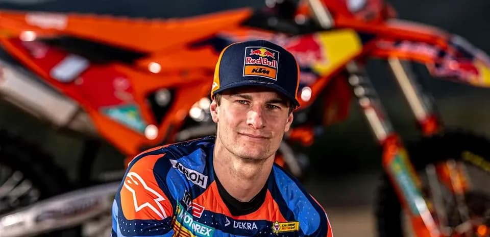 Motocross racer posing with KTM motorcycle