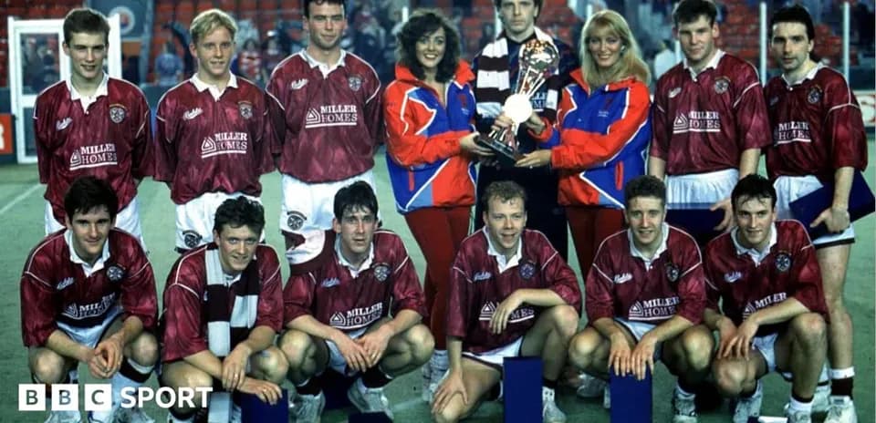 Football team posing with trophy and awards