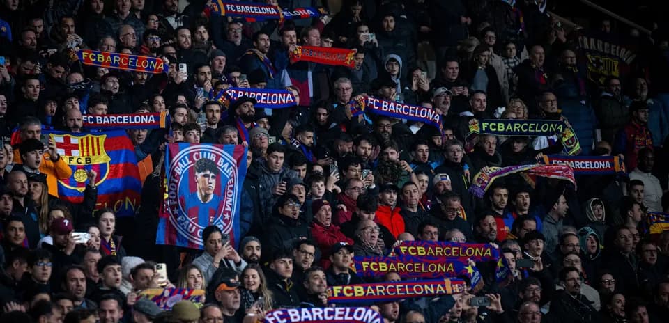 FC Barcelona fans holding scarves in stadium