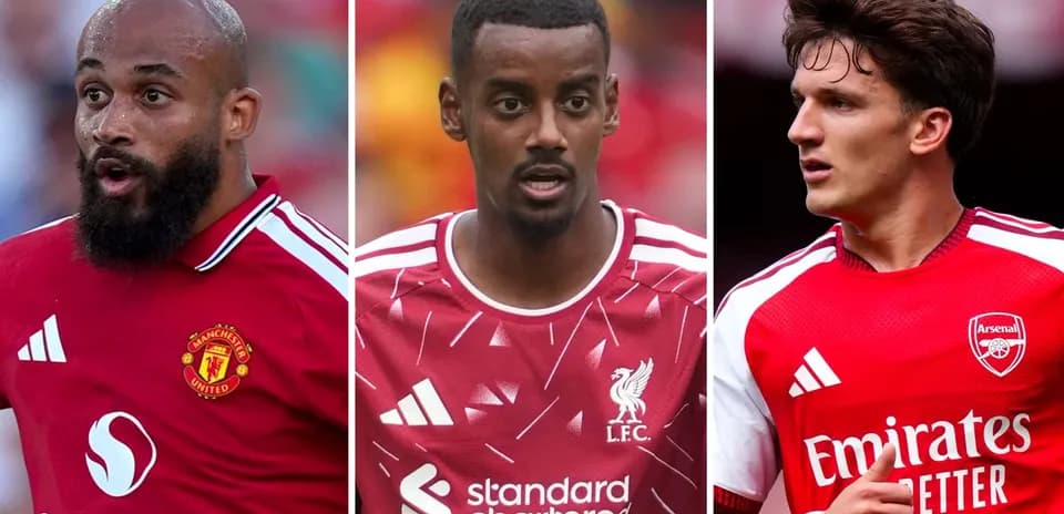 Three football players in club jerseys on pitch