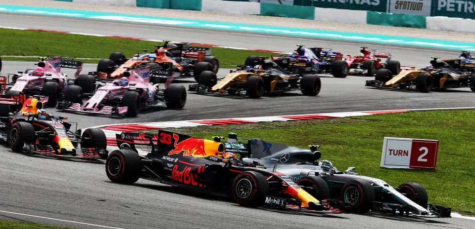 Formula 1 cars racing at Turn 2 of circuit