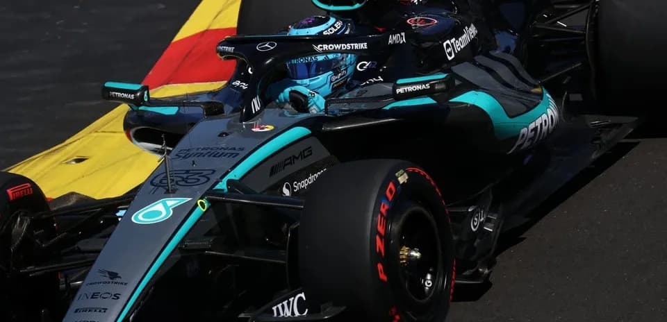 Mercedes F1 car navigating a corner on track