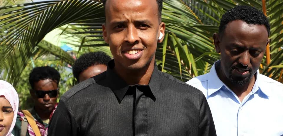 Young man smiling with group in background