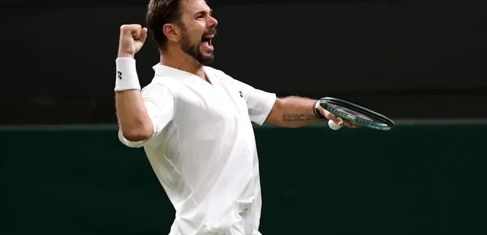 Tennis player celebrating with racket during match