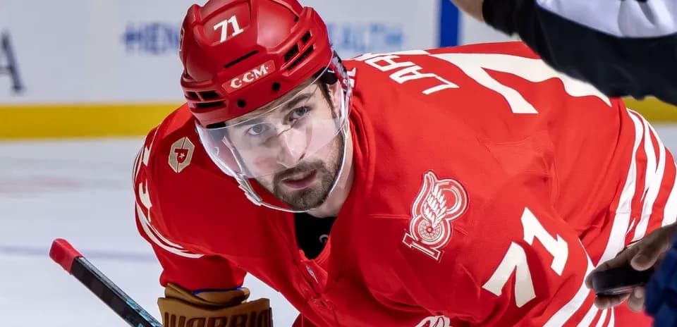 Hockey player in red uniform preparing for faceoff