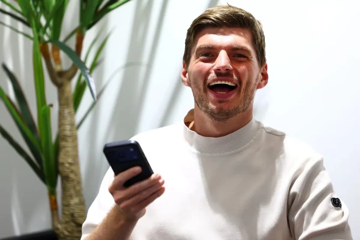 Young man laughing while holding a smartphone