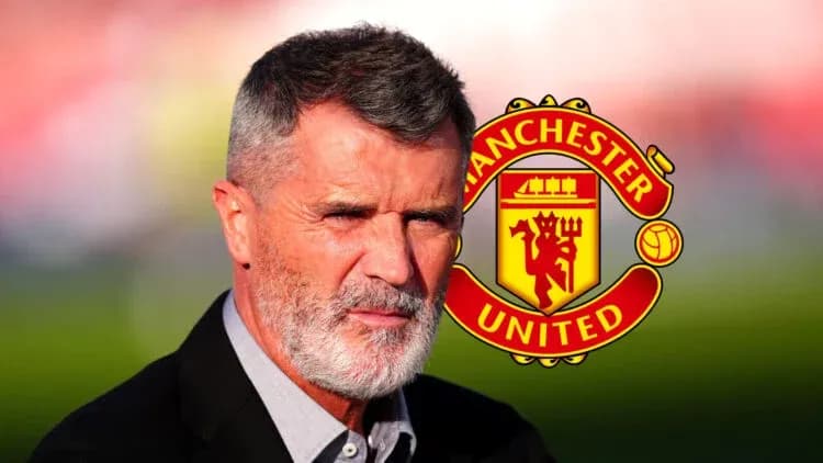 Man in suit with gray beard near Manchester United logo