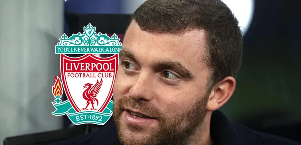 Man speaking with Liverpool FC logo in background