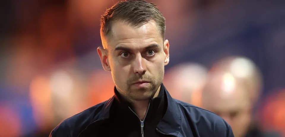 Coach observing from the sidelines during match