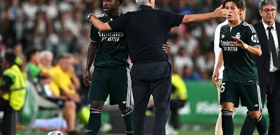 Real Madrid players receiving instructions from coach