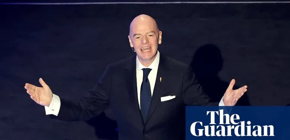 FIFA president speaking at an event with arms raised