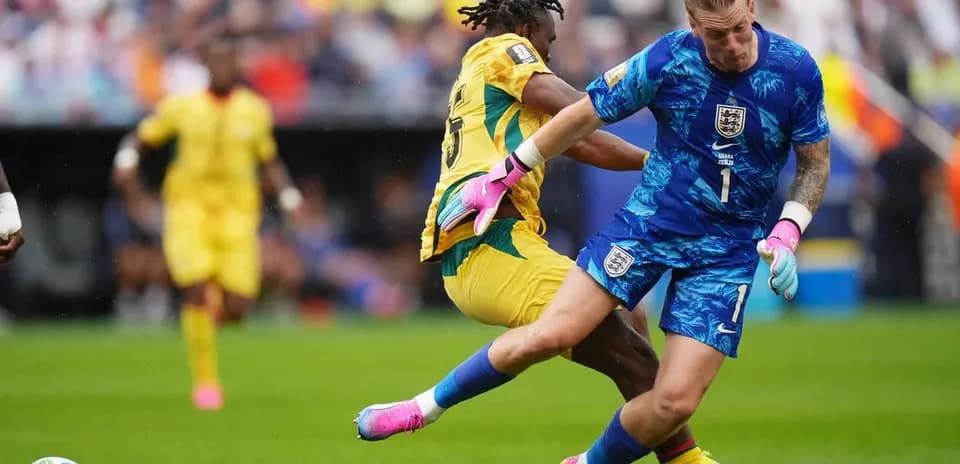 Goalkeeper colliding with an opposing player during match