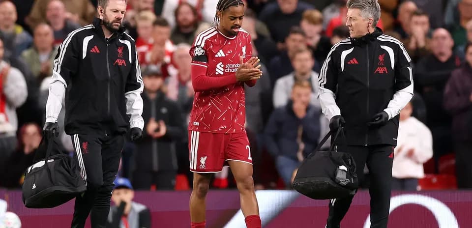 Liverpool player being assisted off the field