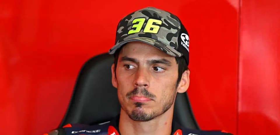 Motorsport athlete wearing cap in team garage