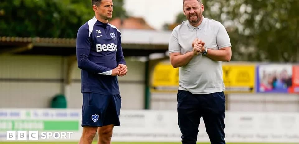 Trainers discussing on the pitch during training session