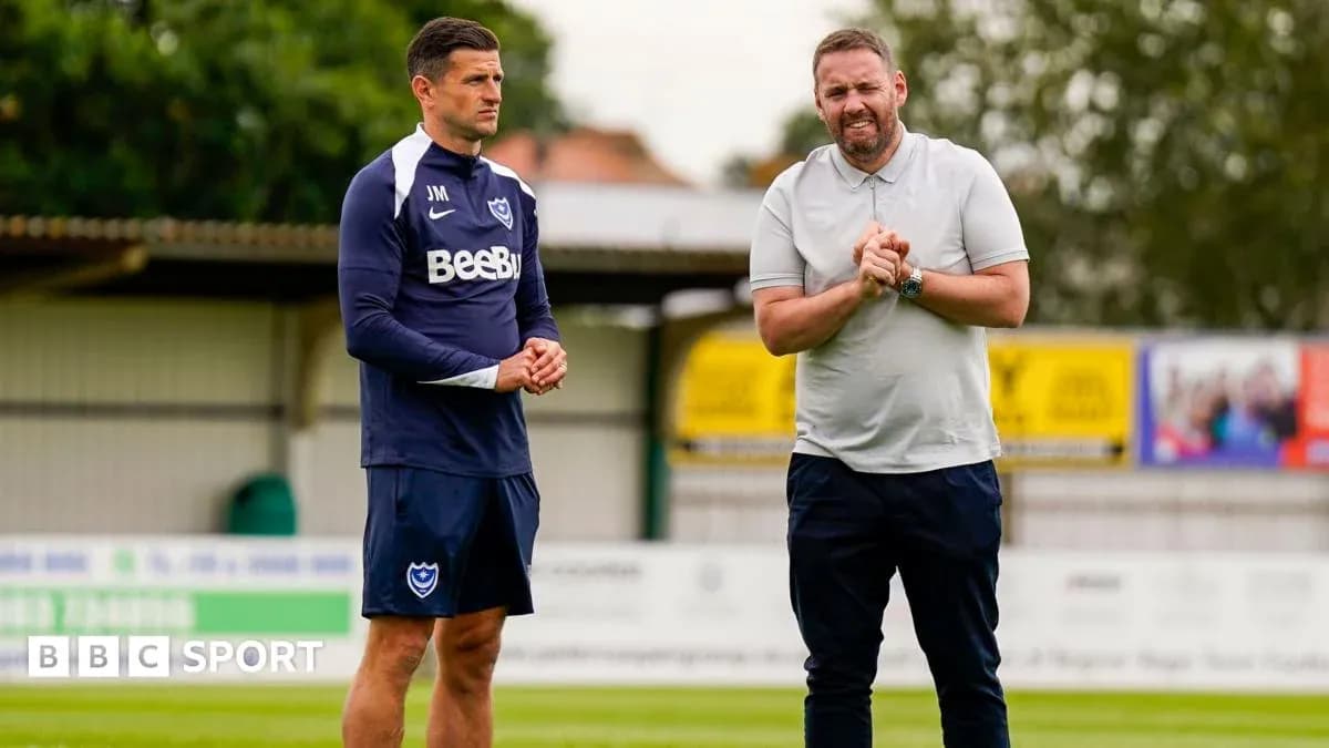 Trainers discussing on the pitch during training session