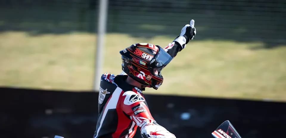Motocross rider celebrating with raised hand