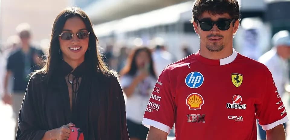 Couple walking at motorsport event, wearing sunglasses