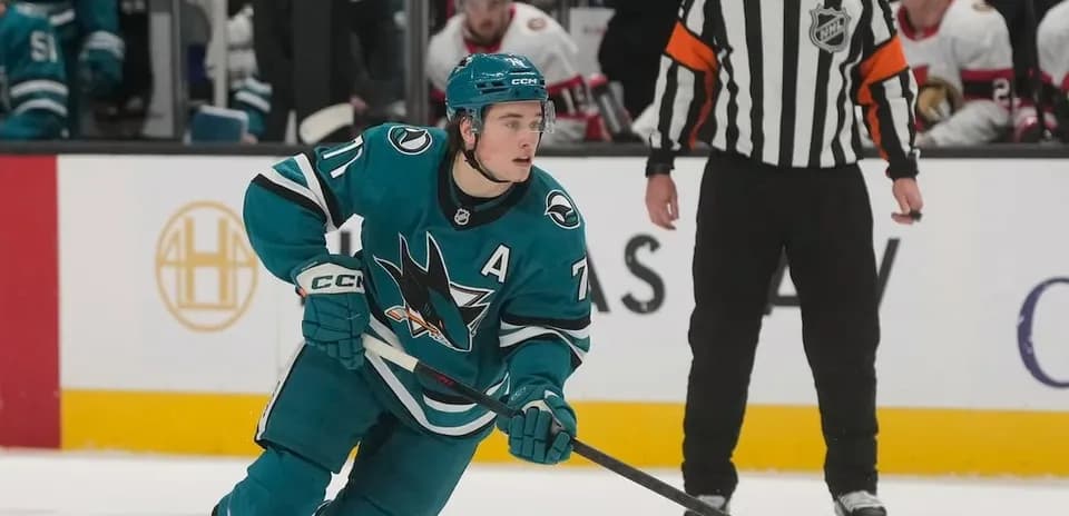 Hockey player skating with puck during game