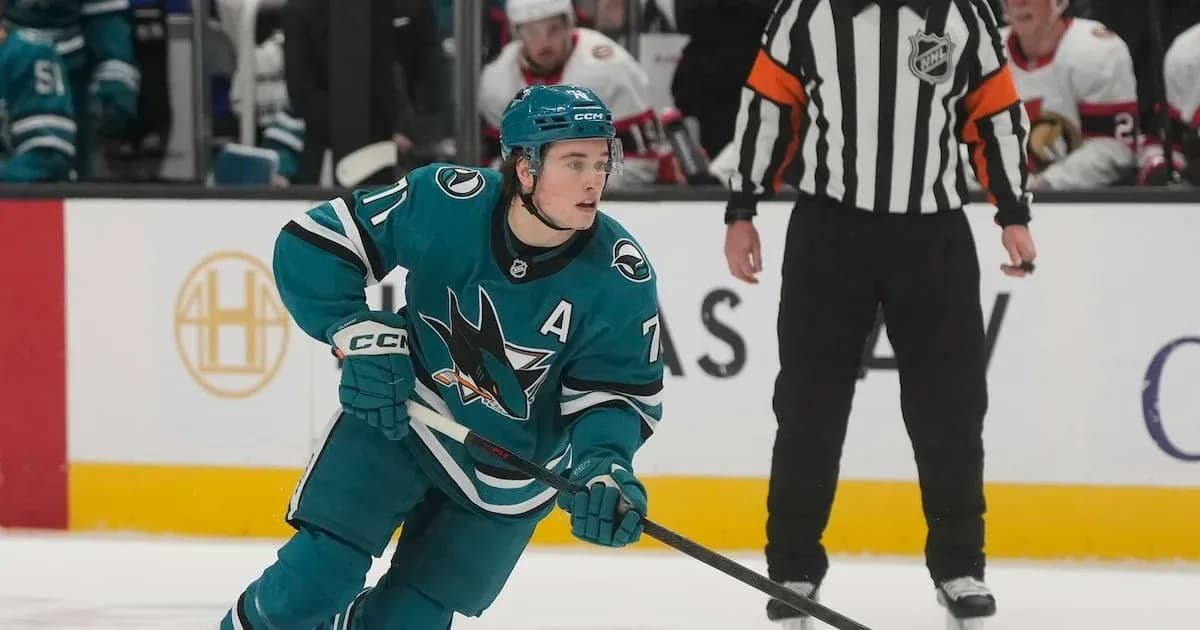 Hockey player skating with puck during game