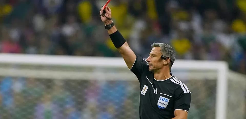 Referee showing red card during football match