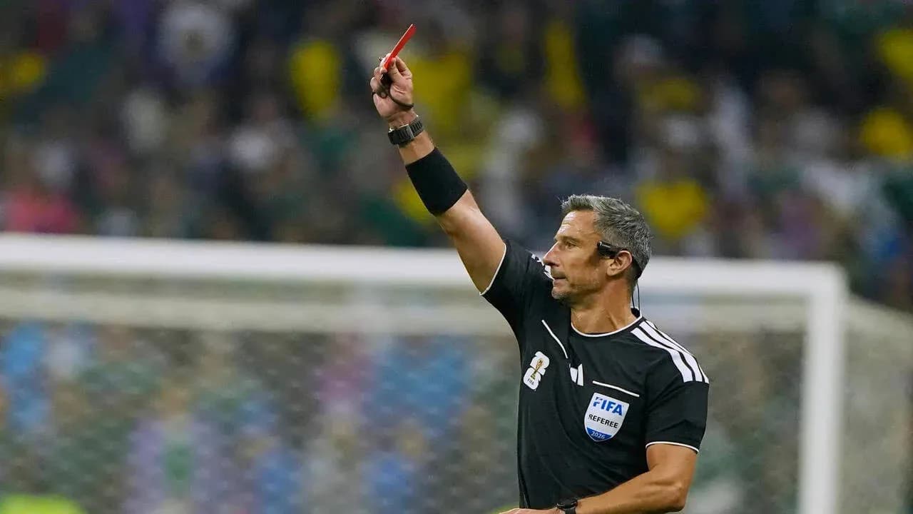 Referee showing red card during football match
