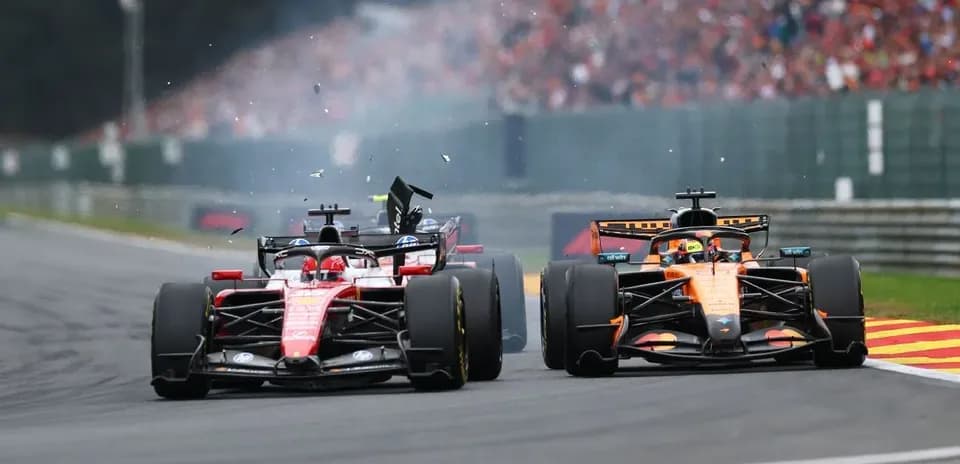 Two Formula 1 cars colliding on the track
