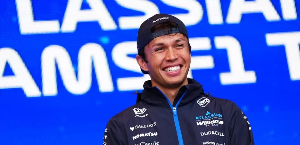 F1 driver smiling during team event backdrop