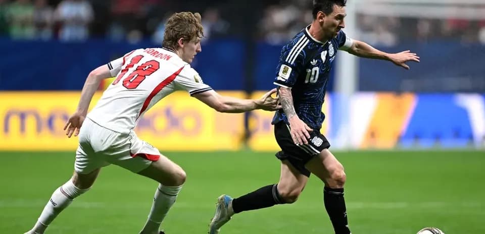 Player dribbling the ball while being challenged