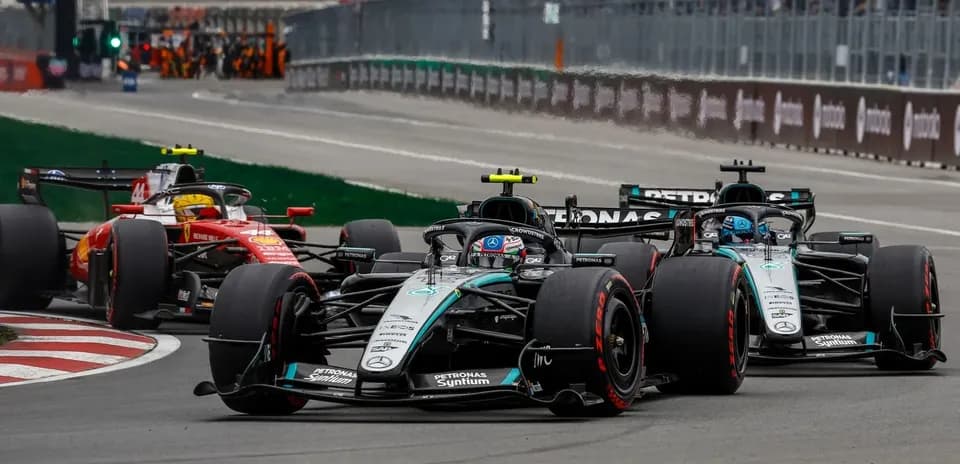 Mercedes and Ferrari cars racing on track