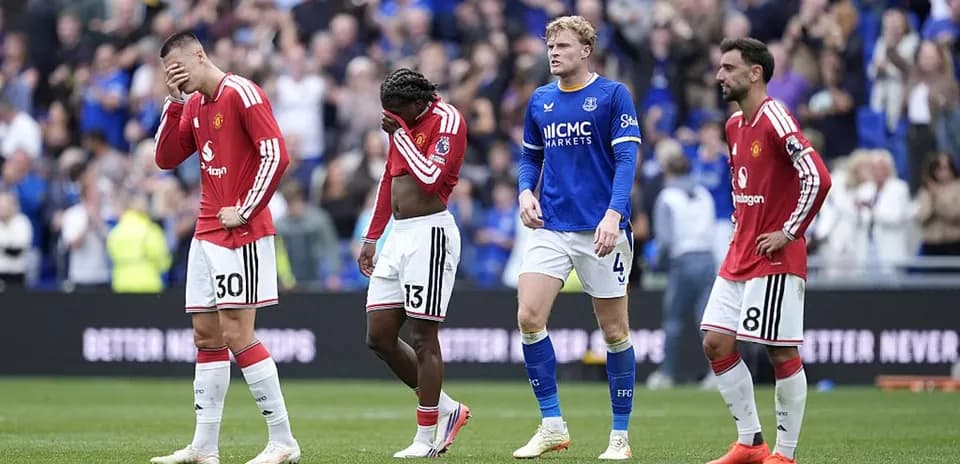 Manchester United players walking off field after match