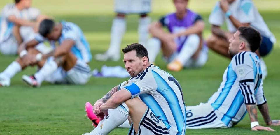 Argentina players seated on the grass after match