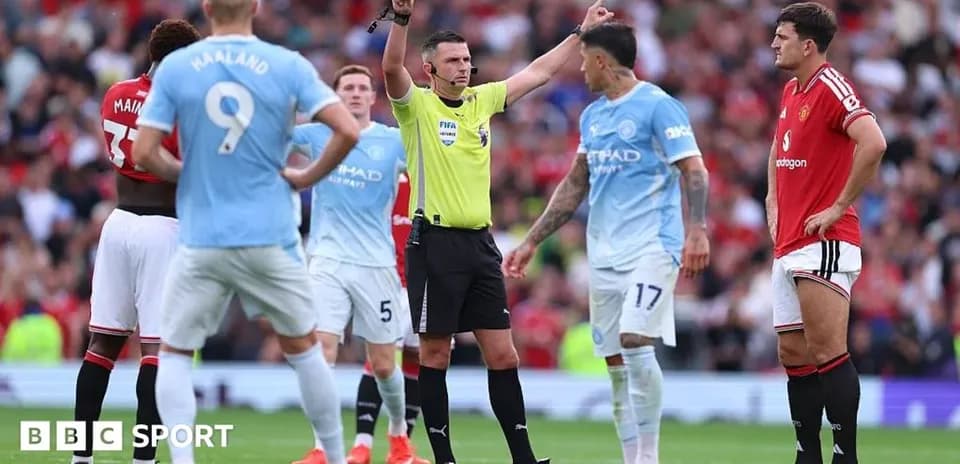Referee discussing with players during match action