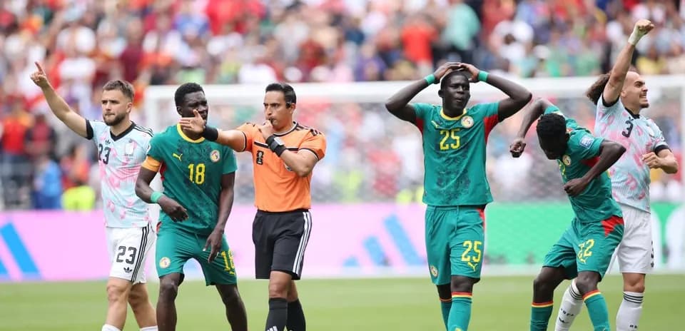 Referee signaling during Senegal football match