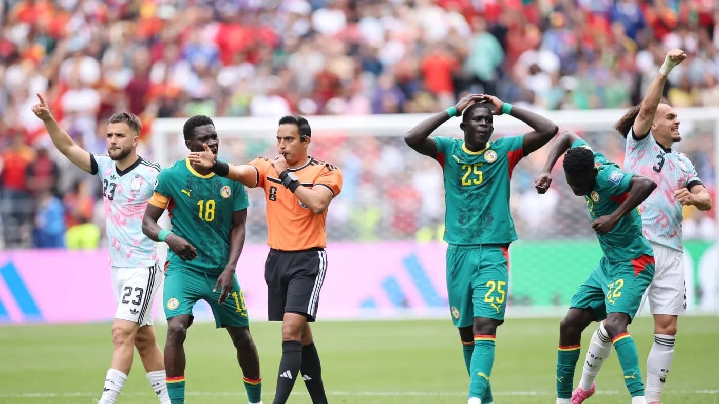 Referee signaling during Senegal football match