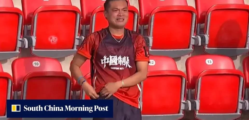 Fan in red shirt celebrating at empty stadium