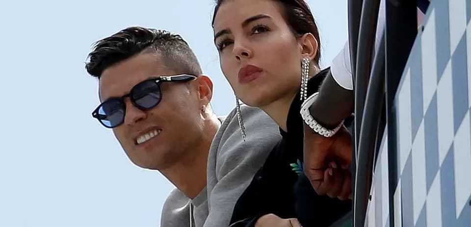 Cristiano Ronaldo and partner watching from balcony