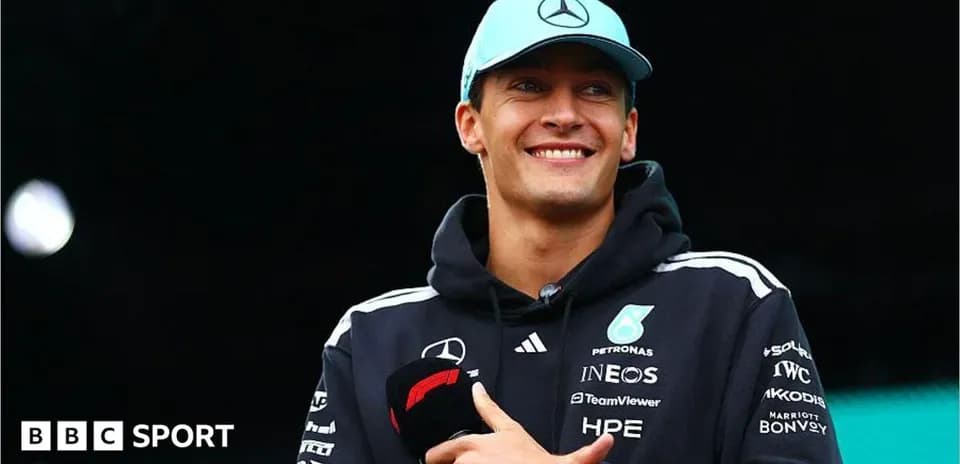 F1 driver smiling during event with microphone