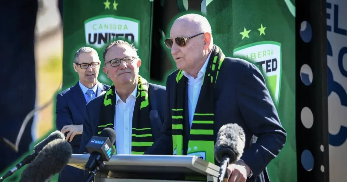 Officials speaking at Canberra United event with scarves