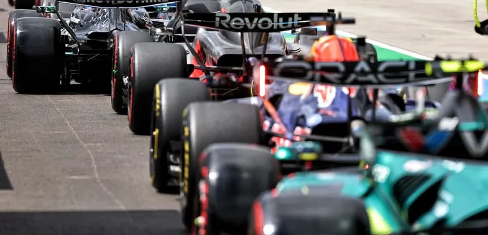 Formula 1 cars lined up in the pit lane