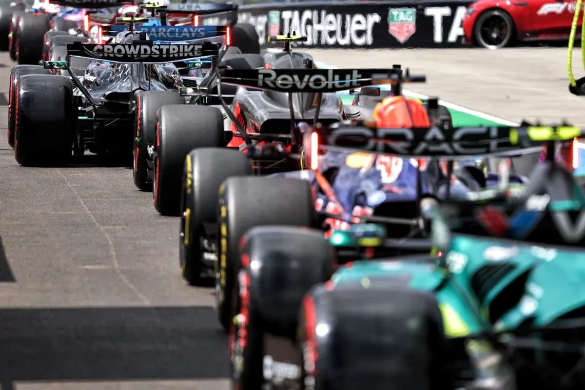 Formula 1 cars lined up in the pit lane