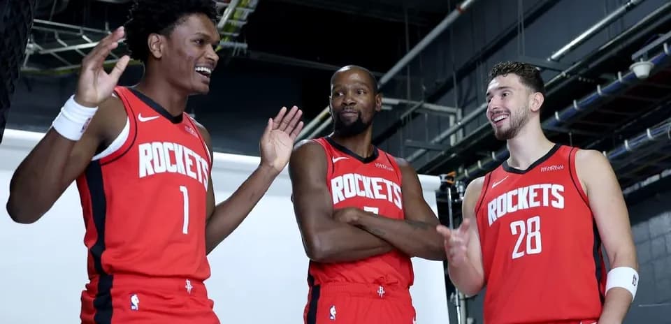 Three players in Houston Rockets jerseys posing together