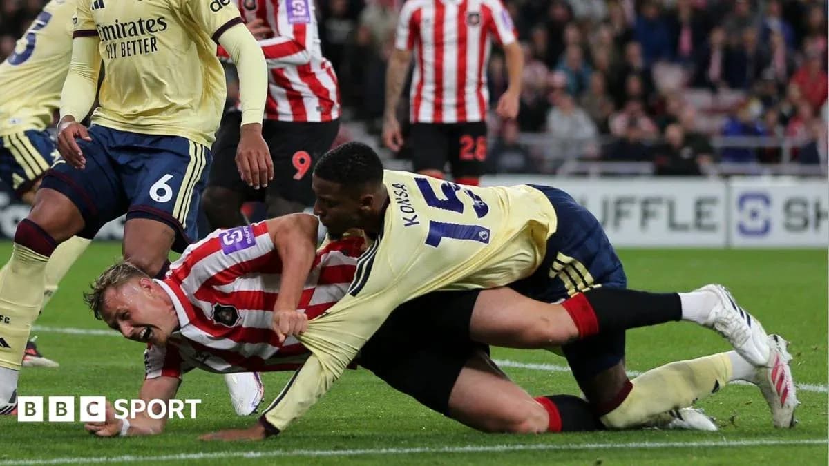 Players in a tackle during a football match
