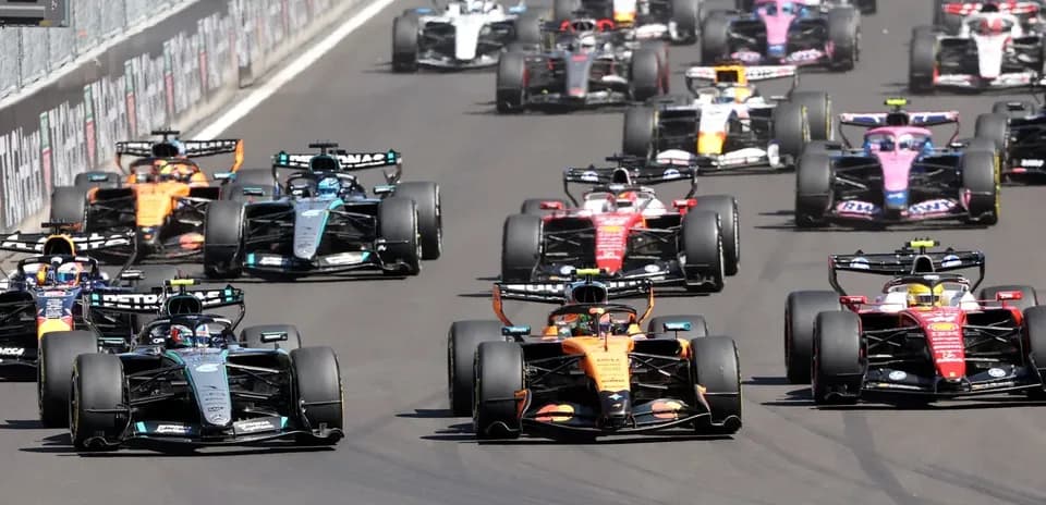 Formula 1 cars racing closely on the track