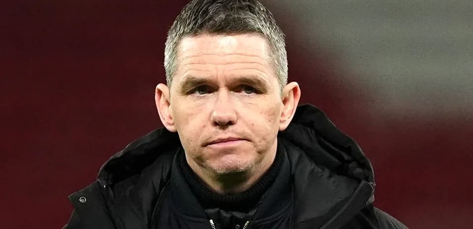 Men's football coach on the sidelines during match