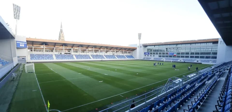Stadium view with players training on the pitch
